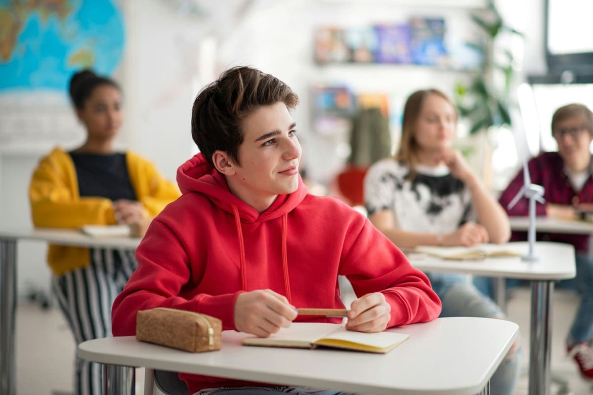Students listening attentively in a bright classroom